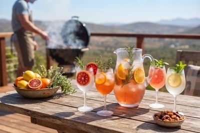 A spread of Tjello spritz variations beside a braai